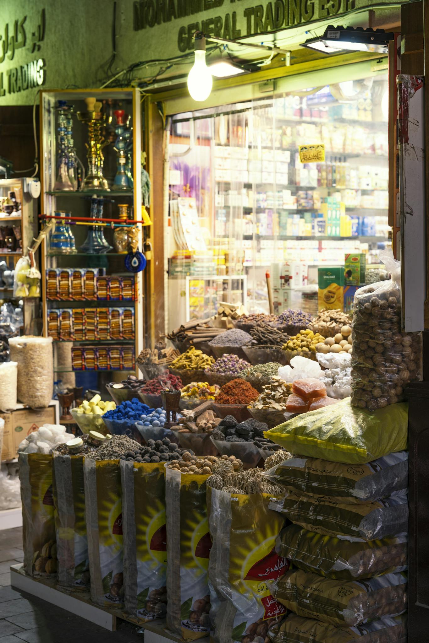 A colorful market stall in Dubai displaying a variety of spices and goods, showcasing local culture.
