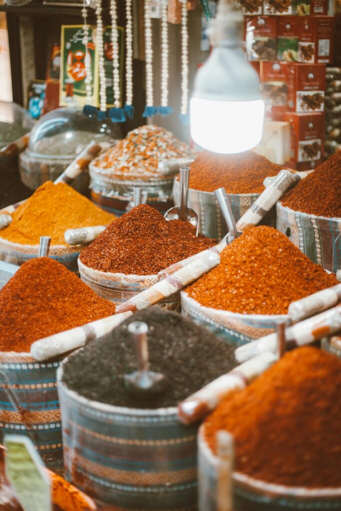 A lively spice market scene showcasing an array of colorful powders and spices in variety.